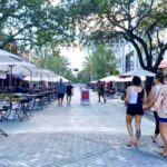 people walking along downtown Clematis Street