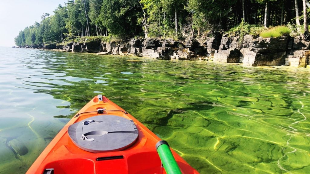Green water and red kayak near Cave Point in Door County, Wisconsin, a Midwest fall getaway favorite