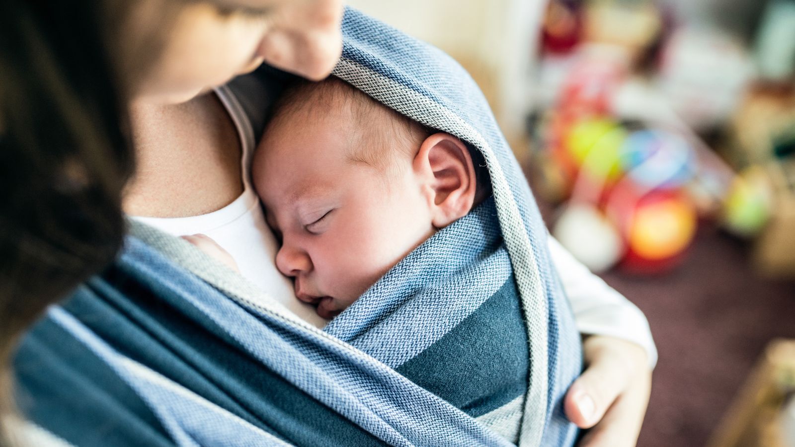 Mother carrying baby in a sling (Photo: Shutterstock)