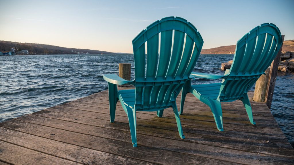 Chairs on a dock on Seneca Lake in New York State, a family vacation destination