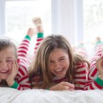 Kids on bed in matching Christmas pajamas (Photo: @heather_lee_wilson via Twenty20)