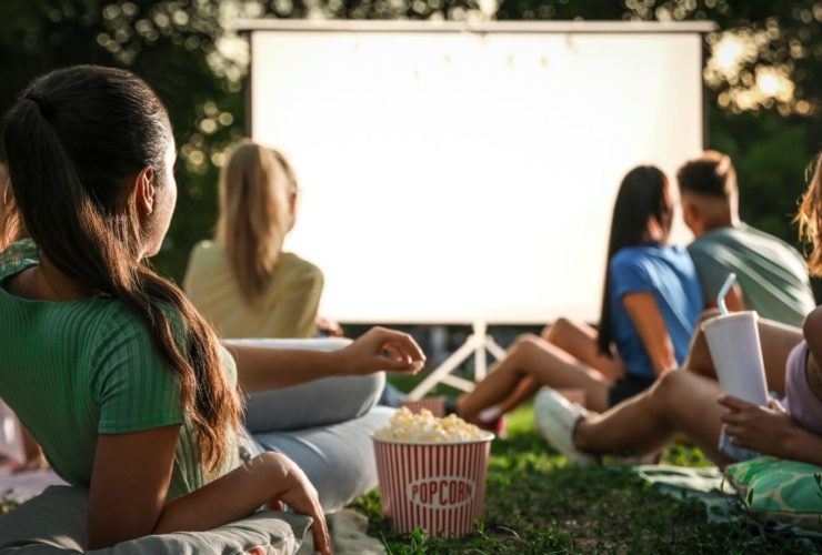 People enjoying an outdoor movie screen (Photo: Shutterstock)