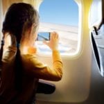 Child taking photo in airplane seat (Photo: Shutterstock)