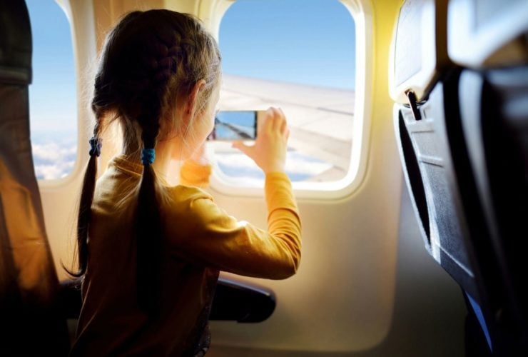 Child taking photo in airplane seat (Photo: Shutterstock)