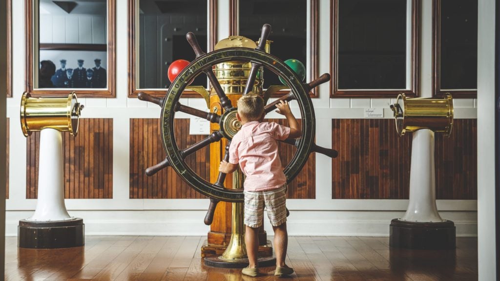 young child with ship wheel at the Titanic Museum in Branson, Missouri