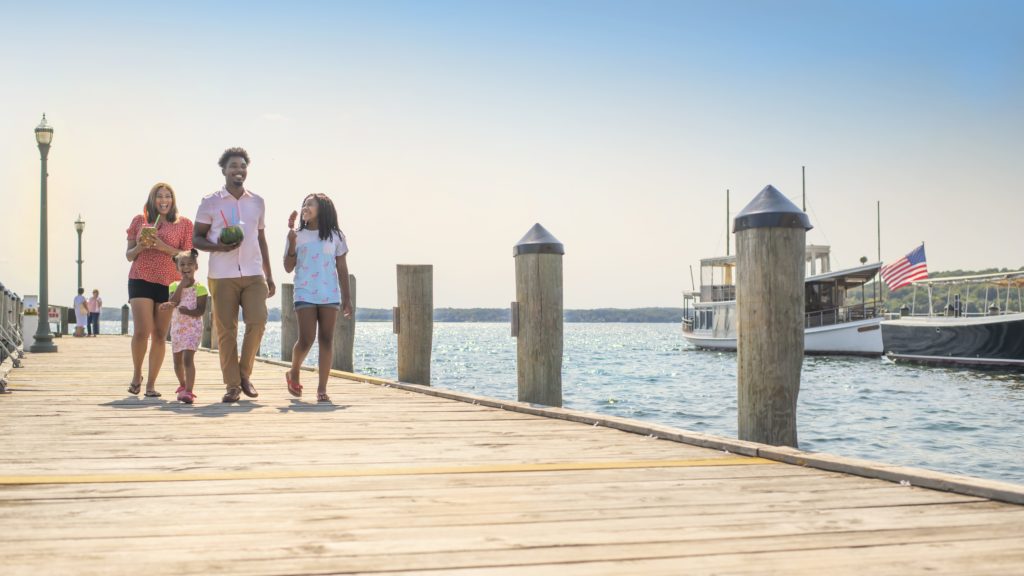 Family on a Midwest vacation walking down a dock with treats