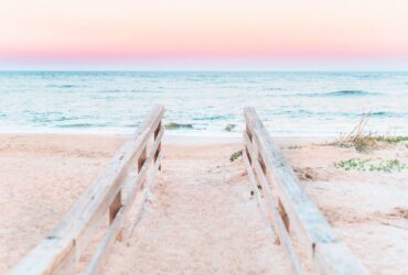 railings leading down to beach at sunset in St. Augustine, Florida