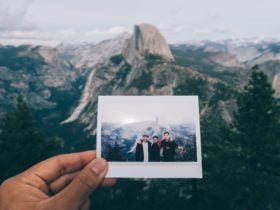 Photo of a photo in front of a view of iconic U.S. attraction Yosemite National Park with Half Dome in the distance