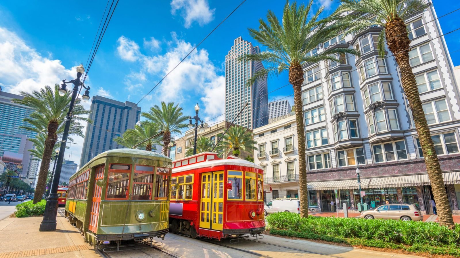 streetcars in New Orleans with the city in the background