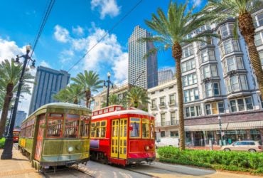 streetcars in New Orleans with the city in the background