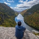 Man sitting on Indian Head Cliff at Adirondack Park, New York (Photo: Shutterstock)