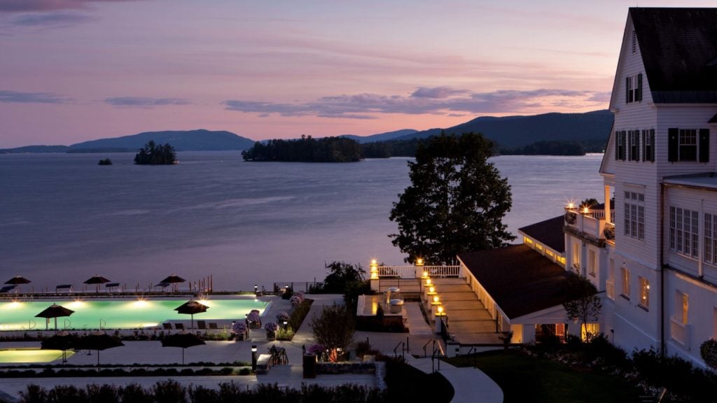 evening with a view of the pool and hotel at The Sagamore Resort on Lake George