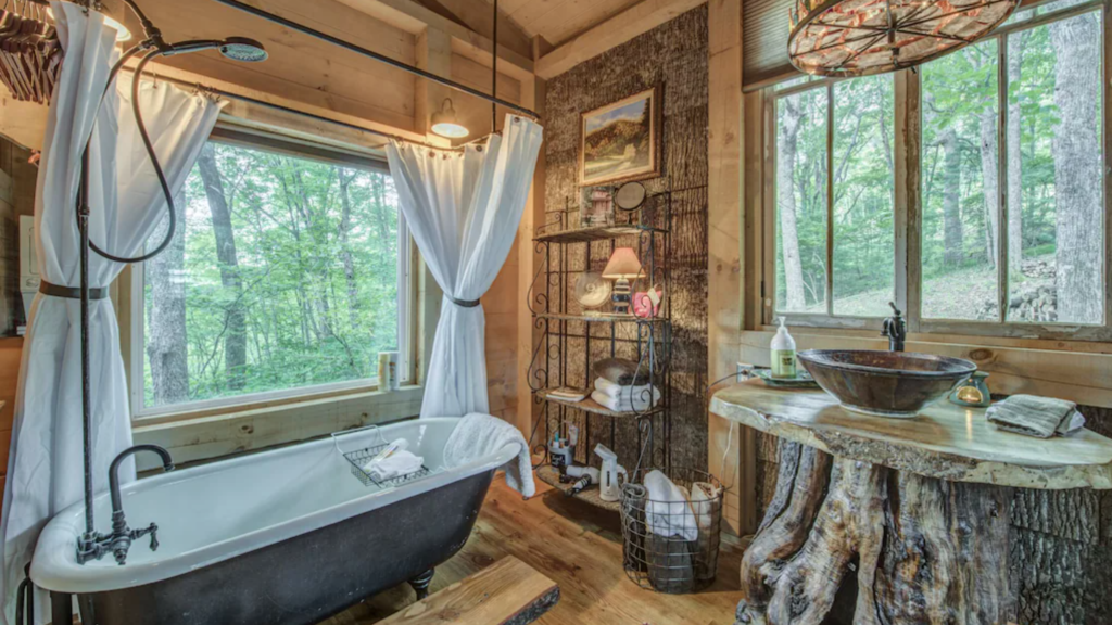 Bathroom with clawfoot tub in the tree house hotel cabin on Little Peak Creek Farm