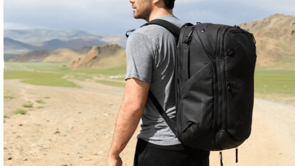 Person on empty road wearing Peak Design’s 45-liter travel backpack