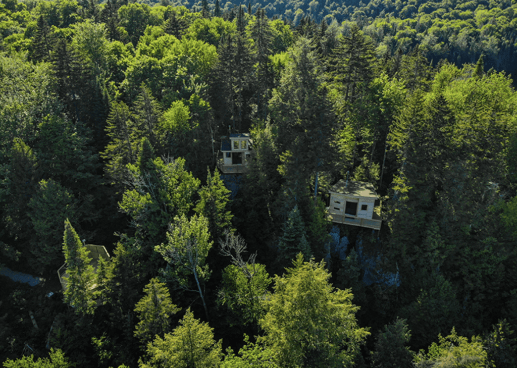 aerial view of forest and treehouses at Mont-Tremblant Treehouses at Refuges Perchés, Quebec, Canada