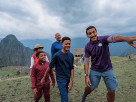 Adventures by Disney adventure guide showing a family the sights of Machu Picchu