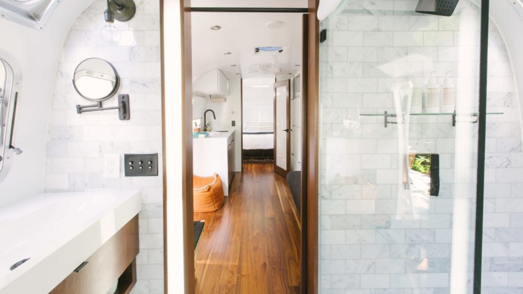 interior image of the Airstream trailers at AutoCamp Russian River, with a view of the bathroom, common area, and bedroom
