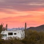Photo of RV in the desert at sunset for story about RVShare