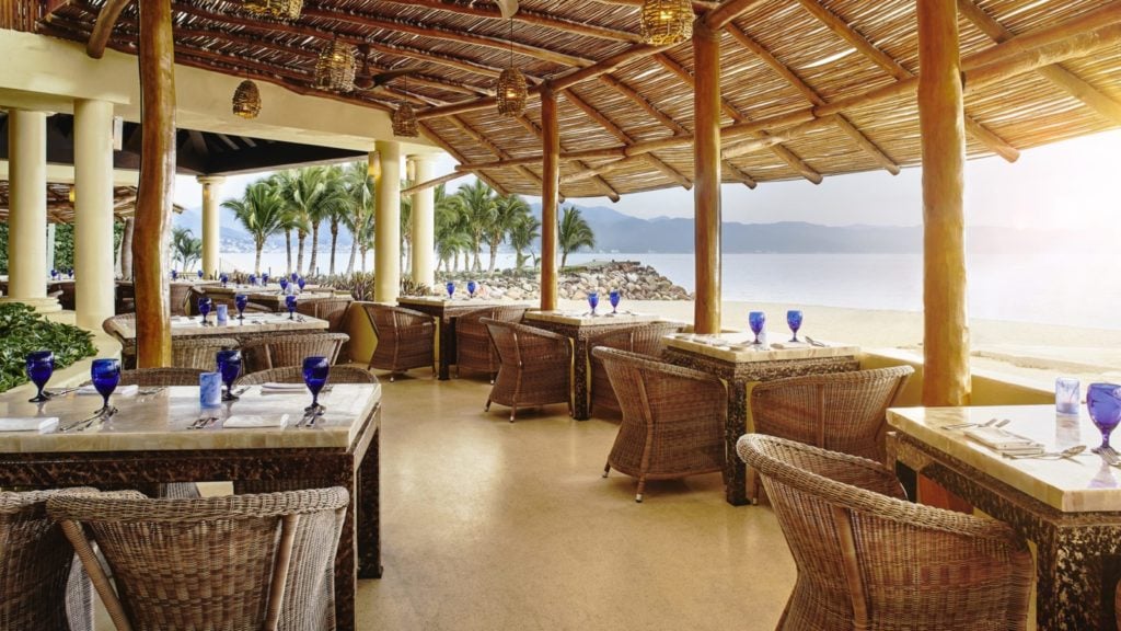 view of tables and ocean beyond the restaurant at Las Casitas restaurant at the Marriott Puerto Vallarta Resort & Spa