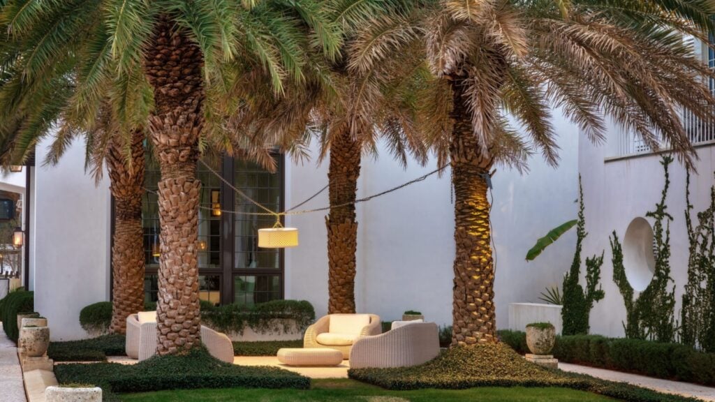 A beautiful collection of chairs under palm trees in Alys Beach, Florida