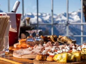 Charcuterie board and chilling wine at Club Med Tignes with snowy mountains in background