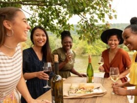 Girlfriends enjoy wine and snacks at a picnic table at Doukenie Winery (Photo: Todd Wright / Visit Loudoun)