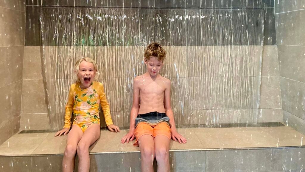 kids in the warm waterfall at the spa at Rush Creek Lodge