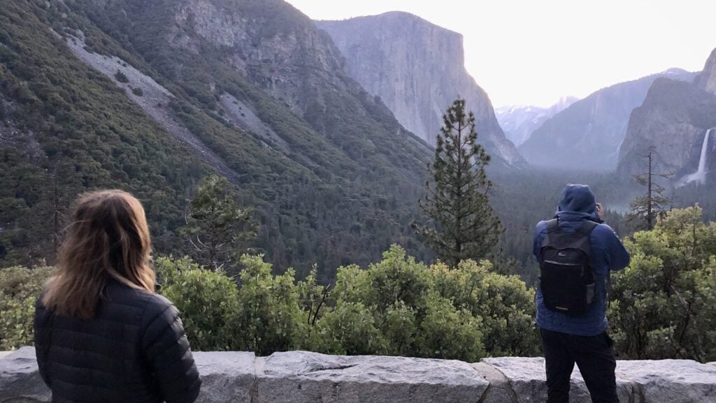 view of two friends taking photos in Yosemite