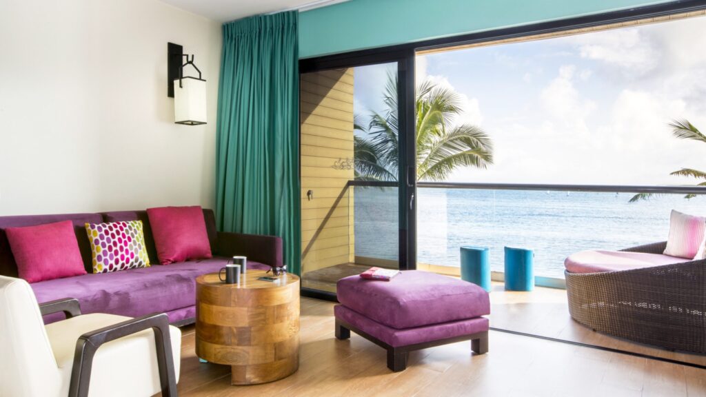 interior view with sitting area next to private deck Aguamarina rooms at Club Med Cancun