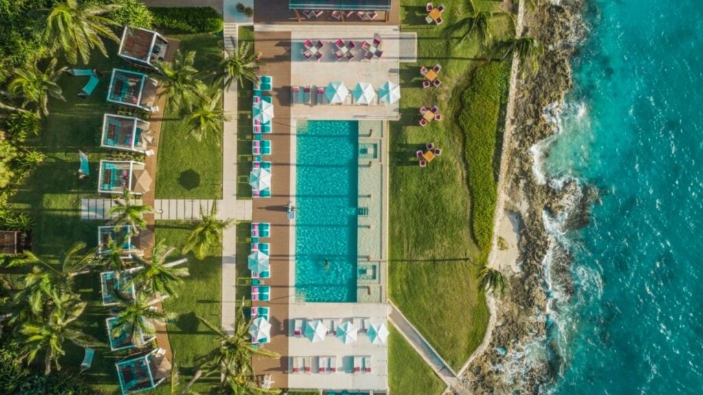 Club Med Cancun Jade Exclusive Collection Space pool aerial view with ocean and cabanas visible