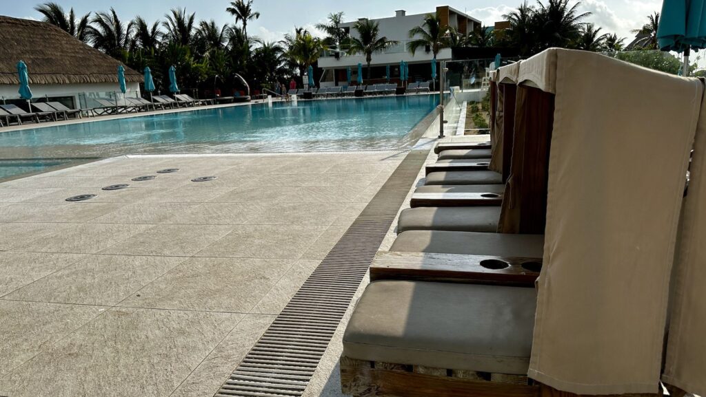 Club Med Cancun family pool in the early morning with view of the kid-sized loungers