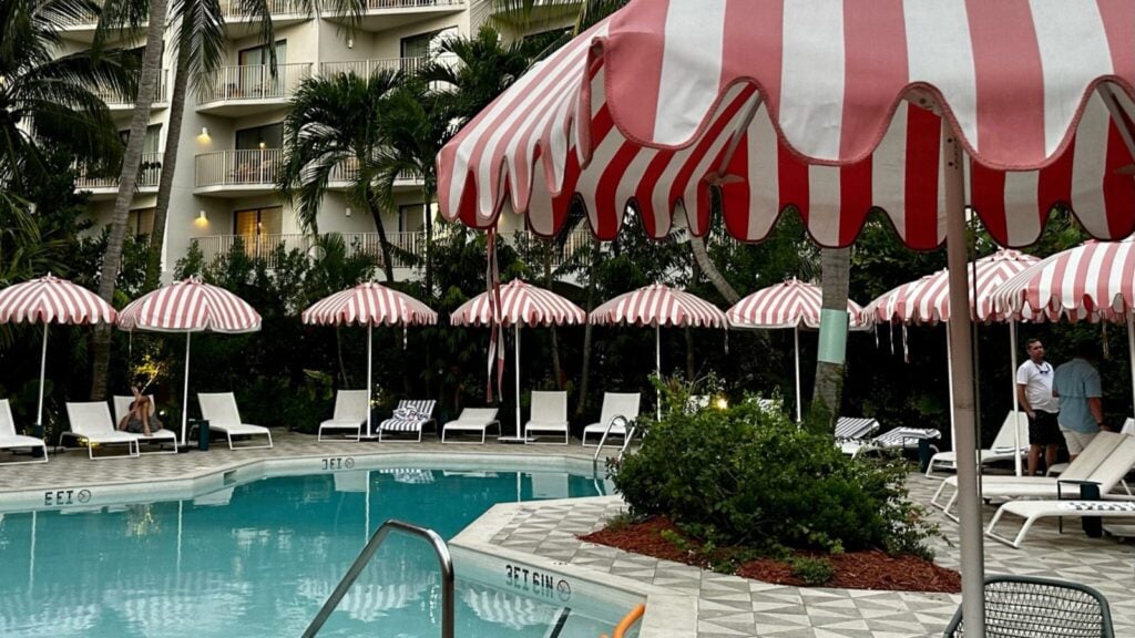 Hampton by Hilton Grand Cayman Seven Mile Beach pool with festive umbrellas and seating