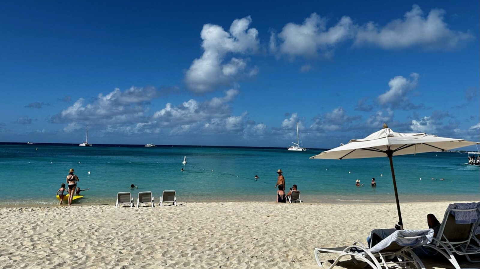 view of Seven Mile Beach from Westin Seven Mile Beach Resort, with umbrella and lounge chairs