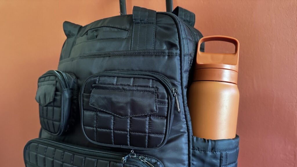 Lifestraw Go waterbottle in a carry-on bag in front of a red wall