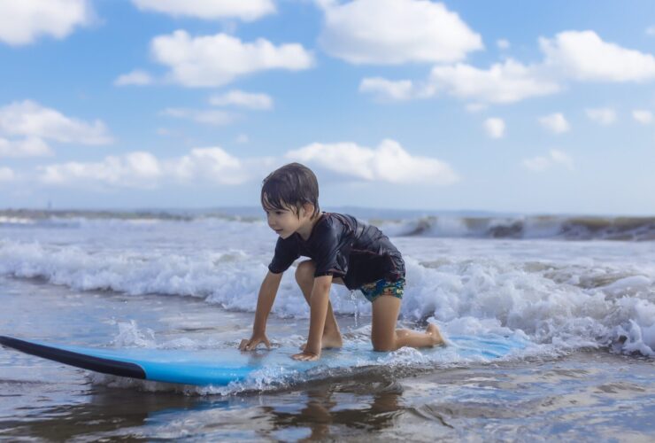 Young child surfing in Bali