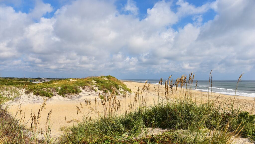 A sandy path through beach dunes down to the ocean in the Outer Banks