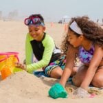 kids digging in the sand at the beach on South Padre Island in Texas