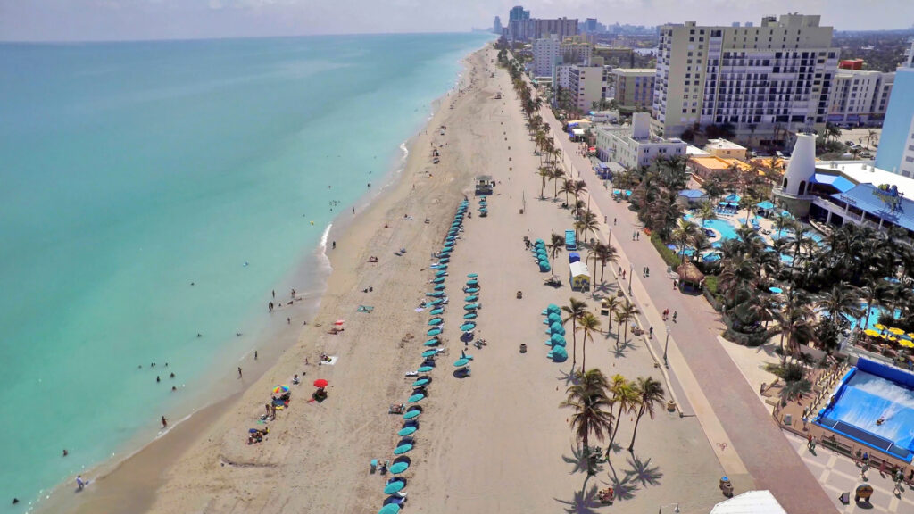 An aerial view of Hollywood Beach and the Broadwalk with umbrellas on the beach