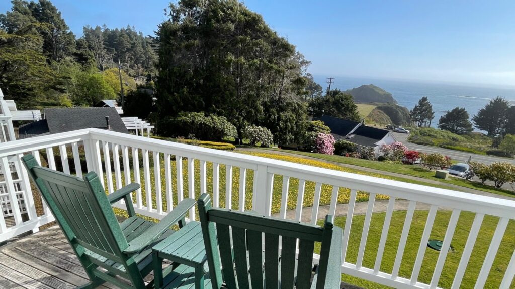 view of rocking chairs on the porch of a room at Little River Inn 