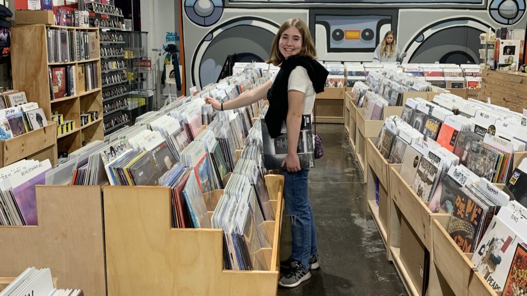 A teenage girl shopping in a record store in St. Pete, FL