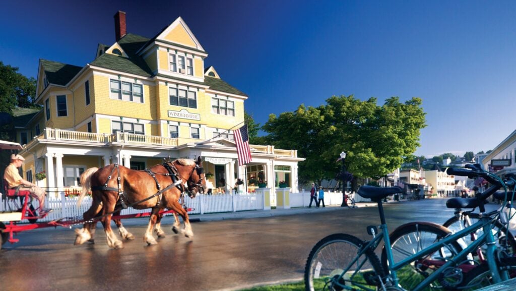 horse and carriage, bikes, and Victorian house on Mackinac Island in summer
