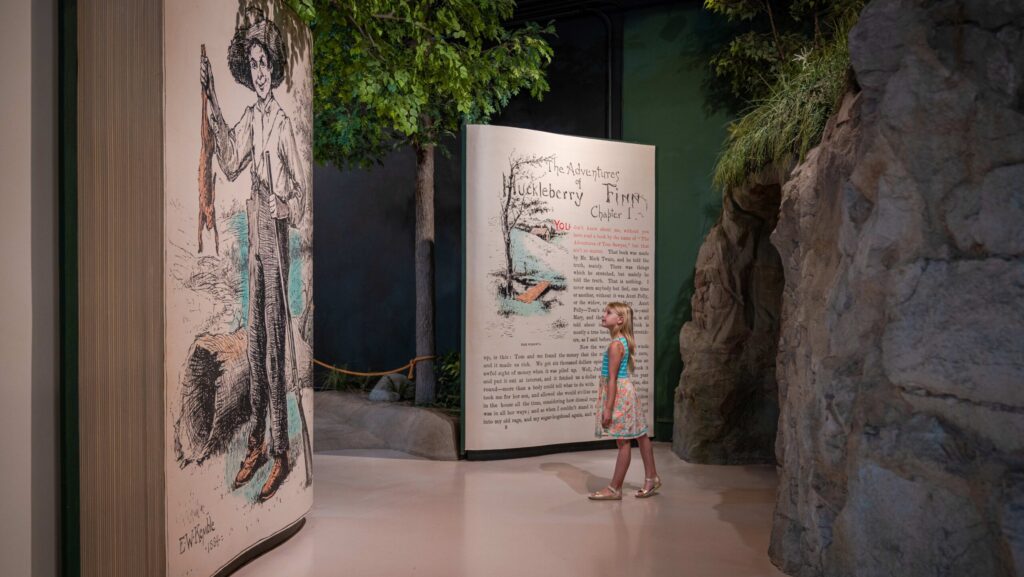 A young girl looking at an exhibit at the Mark Twain Boyhood Home Museum