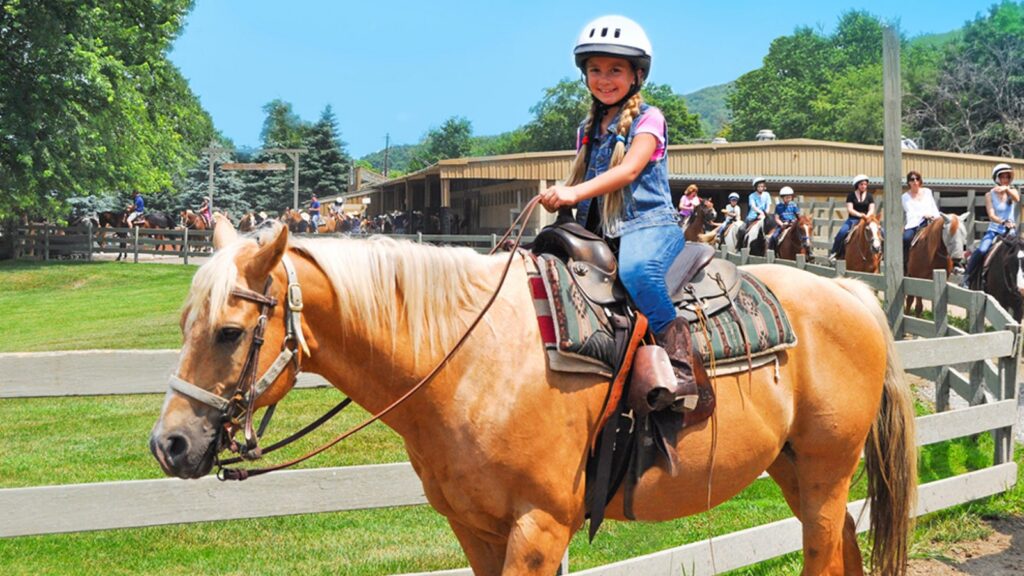 A girl riding a horse at Rocking Horse Ranch Resort