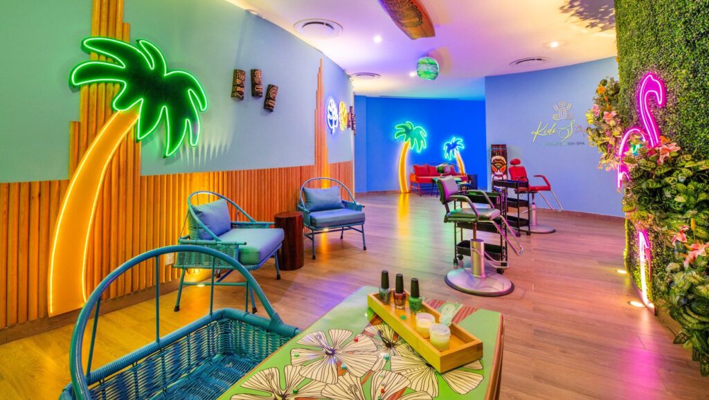 A brightly colored kids spa area with neon signage at Sensira Resort & Spa