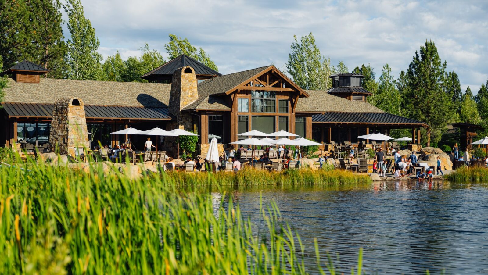 People of all ages enjoying the Lakehouse at Sunriver Resort on a sunny day