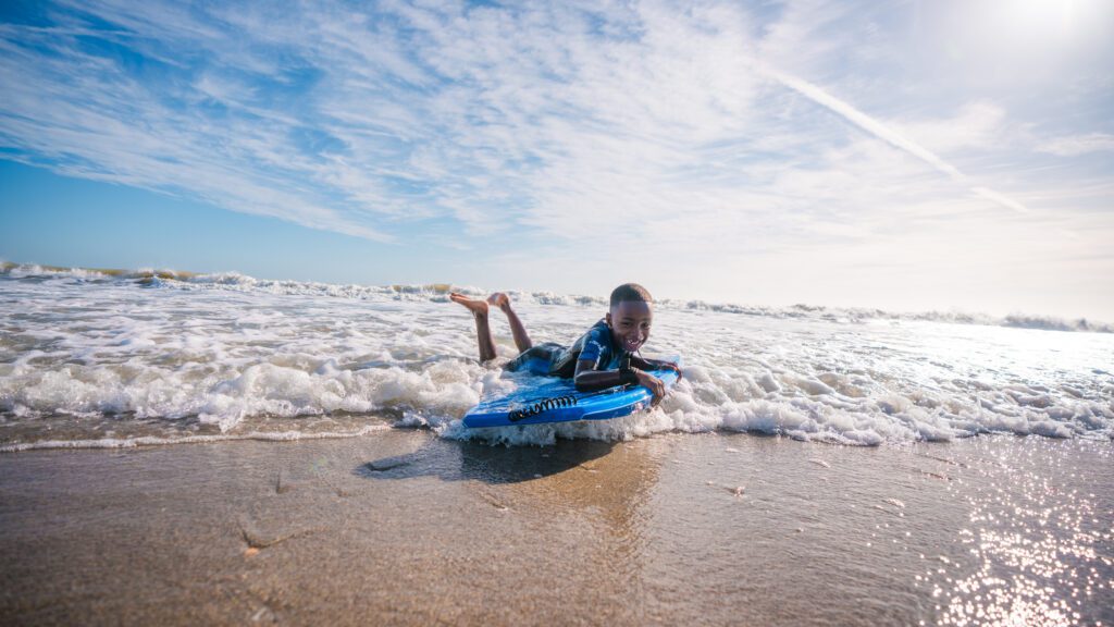 A boy bodyboarding in Cocoa Beach