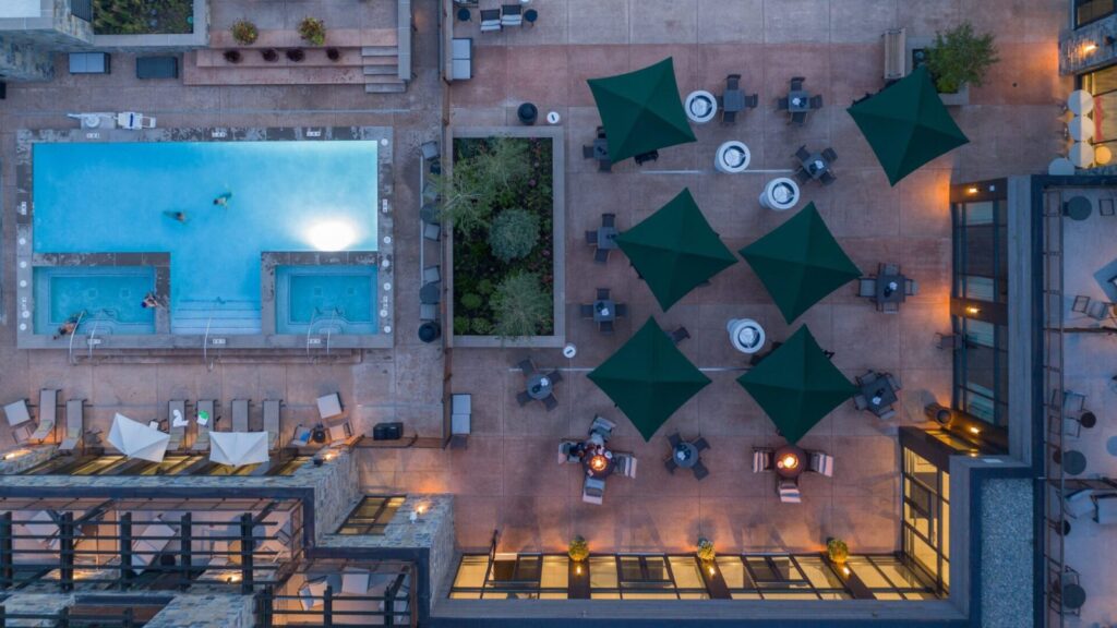 Limelight Hotel Ketchum aerial view of pool and patio in the evening