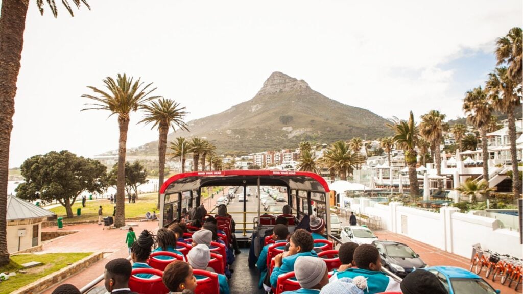 people riding on a double decker tourist bus in Cape Town, South Africa