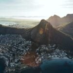 Birds eye view of city of cape town with beautiful beaches and mountain range on a sunny day. Aerial view of Cape Town city with Devil's Peak.