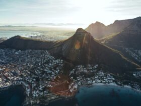 Birds eye view of city of cape town with beautiful beaches and mountain range on a sunny day. Aerial view of Cape Town city with Devil's Peak.